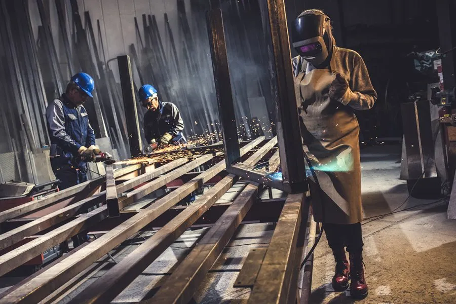 Welder fabricating steel components